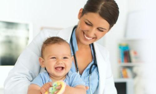 Pediatric nurse practitioner smiling with child patient
